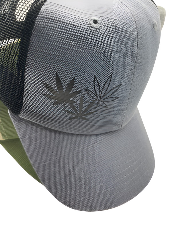 Close up of black three cannabis leaf design on grey hemp novelty snapback hat